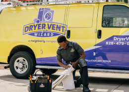 A DVW technician works beside a yellow van.