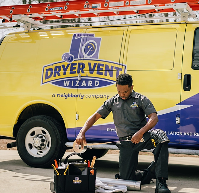 A technician sits besude a DVW van.