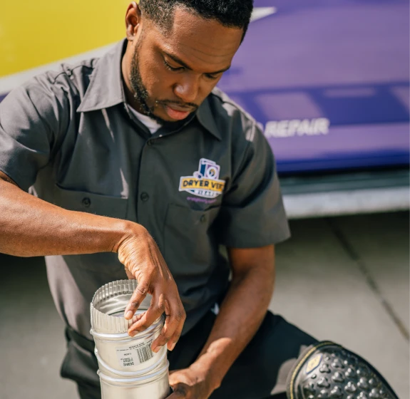 Dryer Vent Wizard tech discussing pipe with customer.