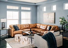 A living room with a sofa placed near a window.