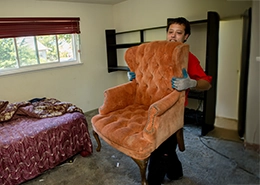 JUK Employee holding sofa.