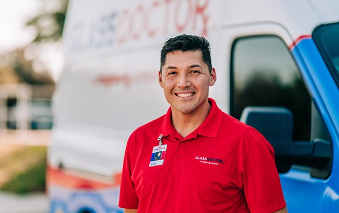 Glass Doctor technician standing beside a service van.