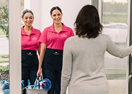 A woman welcoming MLY technicians at her home door.