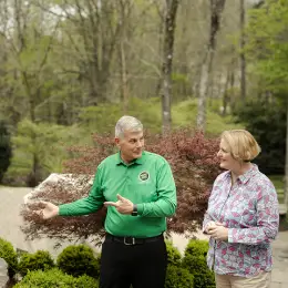 MOJ worker and a customer meet in the garden.