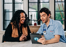Mr. Appliance employee discussing with a client using a tablet.