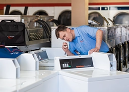 Mr. Appliance employee inspecting a desktop.