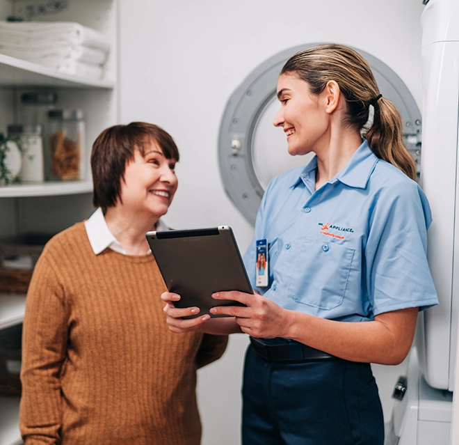 Mr. Appliance employee discussing with a client using an iPad.