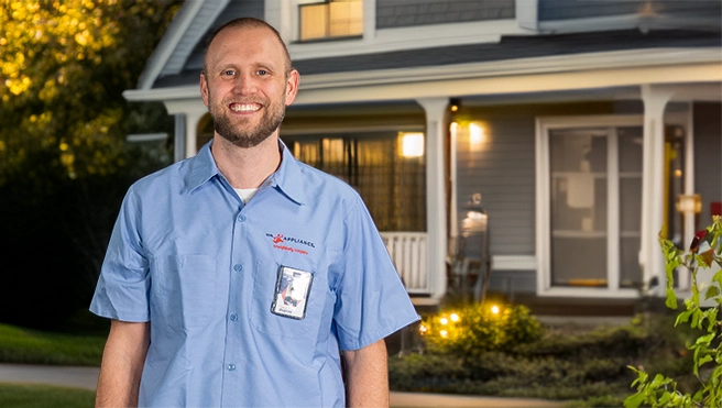Mr. Appliance employee standing in front of a house.