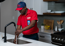 Mr. Rooter plumber fixing a clogged drain.