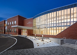 Modern brick building with a large glass facade.