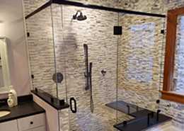 A modern bathroom shower featuring a glass enclosure.