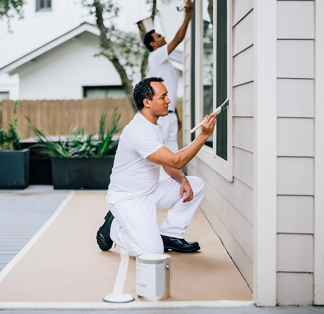 PTP workers painting a home.