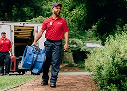 Rainbow Restoration employee holding water damage restoration equipment.