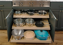 Cabinet with neatly arranged pots and cups.