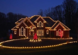 A big house brightly decorated with numerous lights.