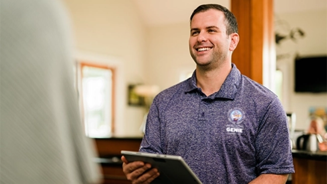 A smiling employee speaking with a customer.