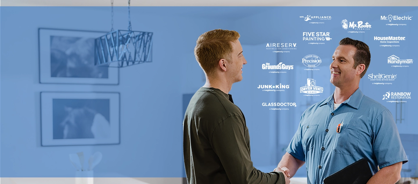 Two men shaking hands with logos behind them.