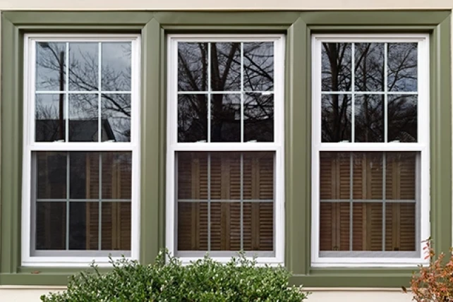 Three rectangular windows with green frames.