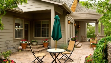 Front patio with greenery and bistro table
