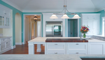 Modern kitchen with teal colored walls.