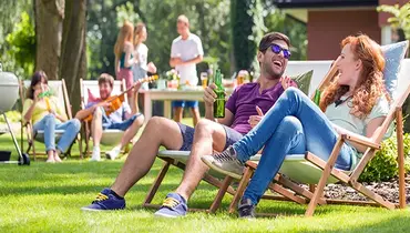 Group of young adults having a party in the backyard.