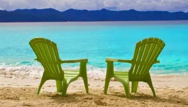 Beach chairs facing the water.