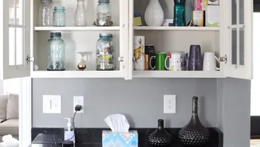 Kitchen cupboard filled with glassware.
