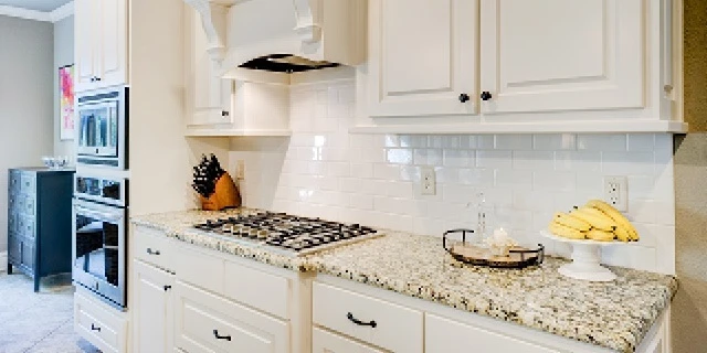 White kitchen wall cabinets and backsplash.