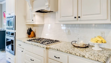 White kitchen wall cabinets and backsplash.