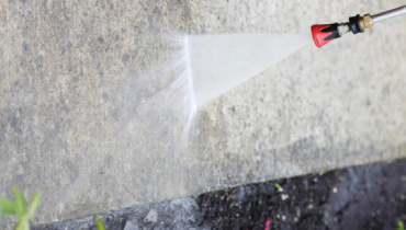Pressure washing concrete.