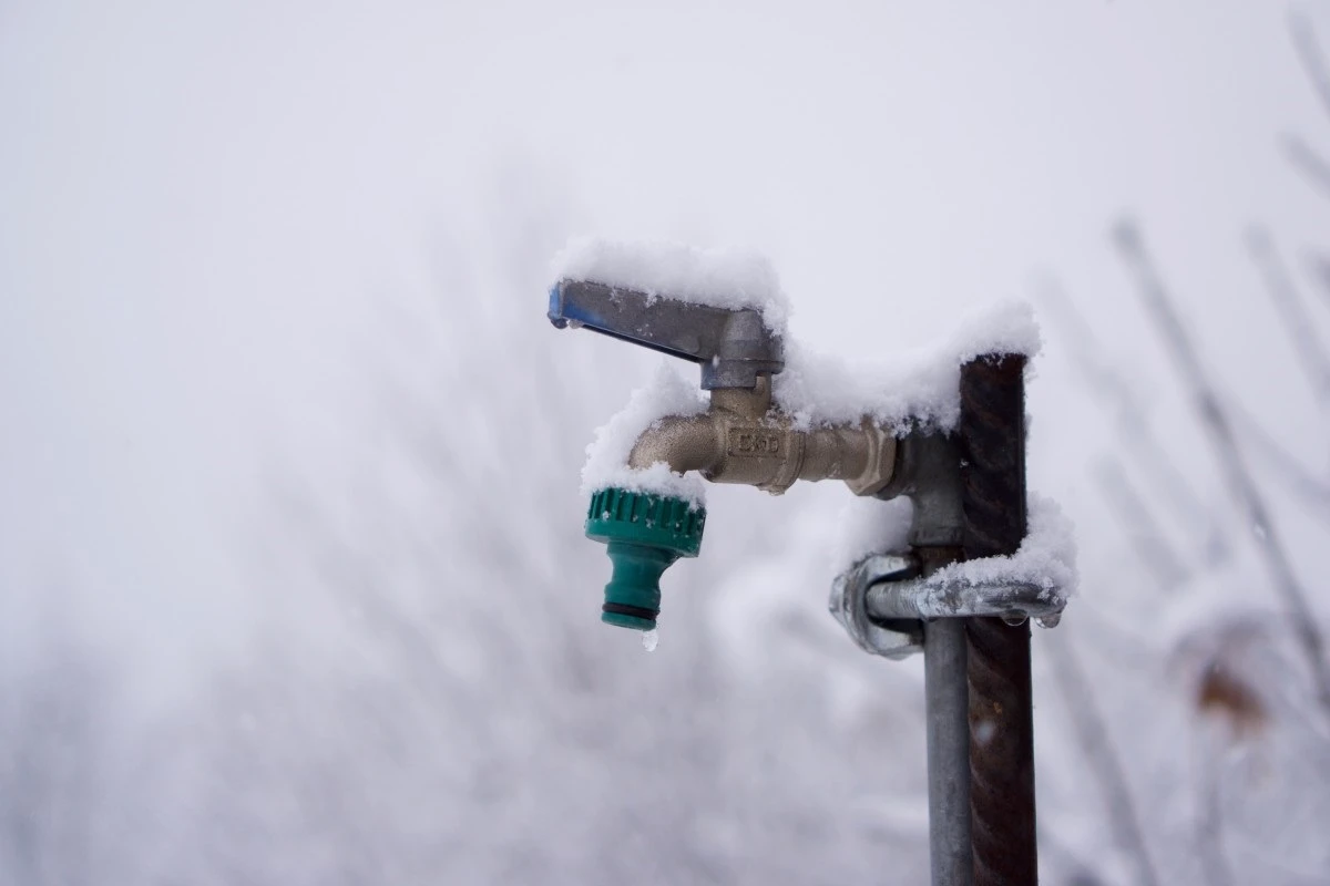 Snow covering frozen spigot.