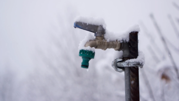 Snow covering frozen spigot.