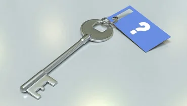 Old fashioned key with blue question mark tag.