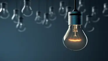 light bulbs handing in front of a dark background.