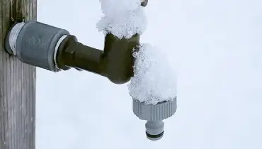 snow-covered outdoor faucet.