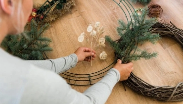 Person creating a wreath.
