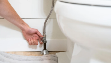 Plumber fixing a toilet
