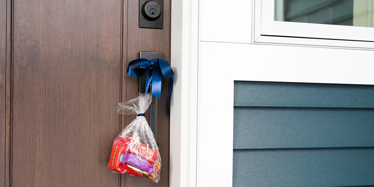 Bag of candy hanging from a doorknob.