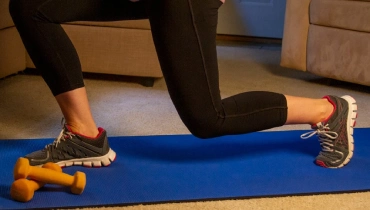 Woman exercising at home on a yoga mat.