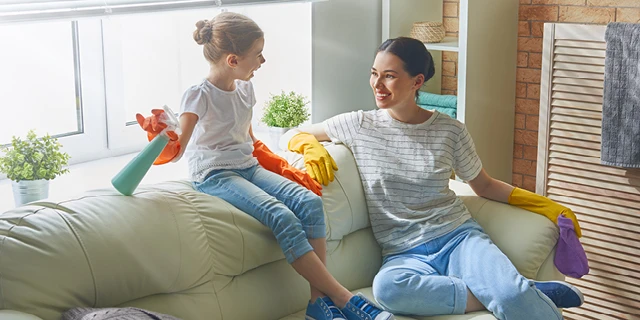 Mother and daughter cleaning the house together.