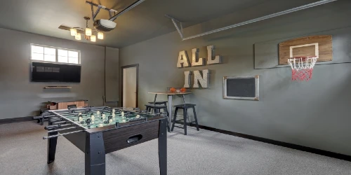 Modern garage interior with fun family play room with hockey table