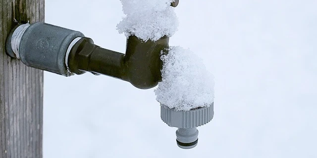 snow-covered outdoor faucet
