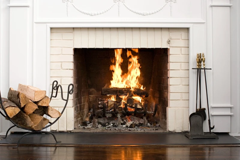 Fireplace burning with brick surround.