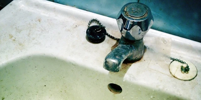 dirty bathroom sink and faucet