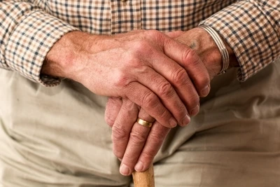 Elderly person with walking stick