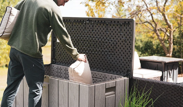 person placing items into a deck box