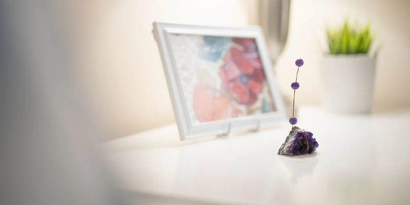 Picture and vase artfully placed on table