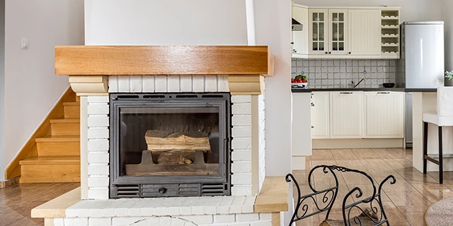 White brick fireplace with wood mantel