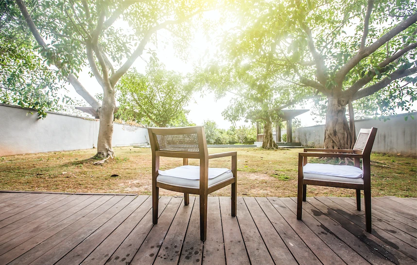 Beautiful backyard view with two chairs facing trees