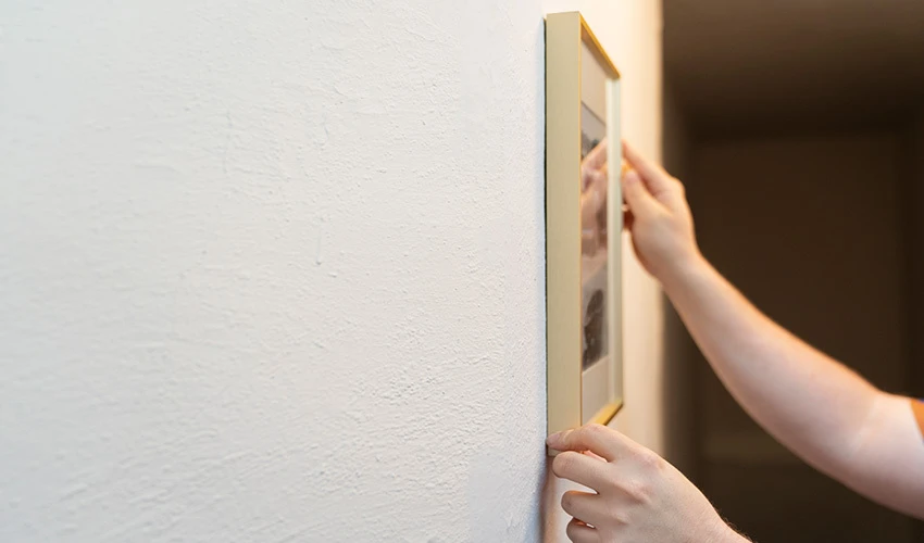 Hanging a picture on a plaster wall